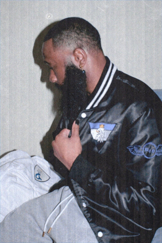Royalty10 R10 black satin jacket with lion emblem and minimalist design representing quiet luxury and timeless confidence in fashion.