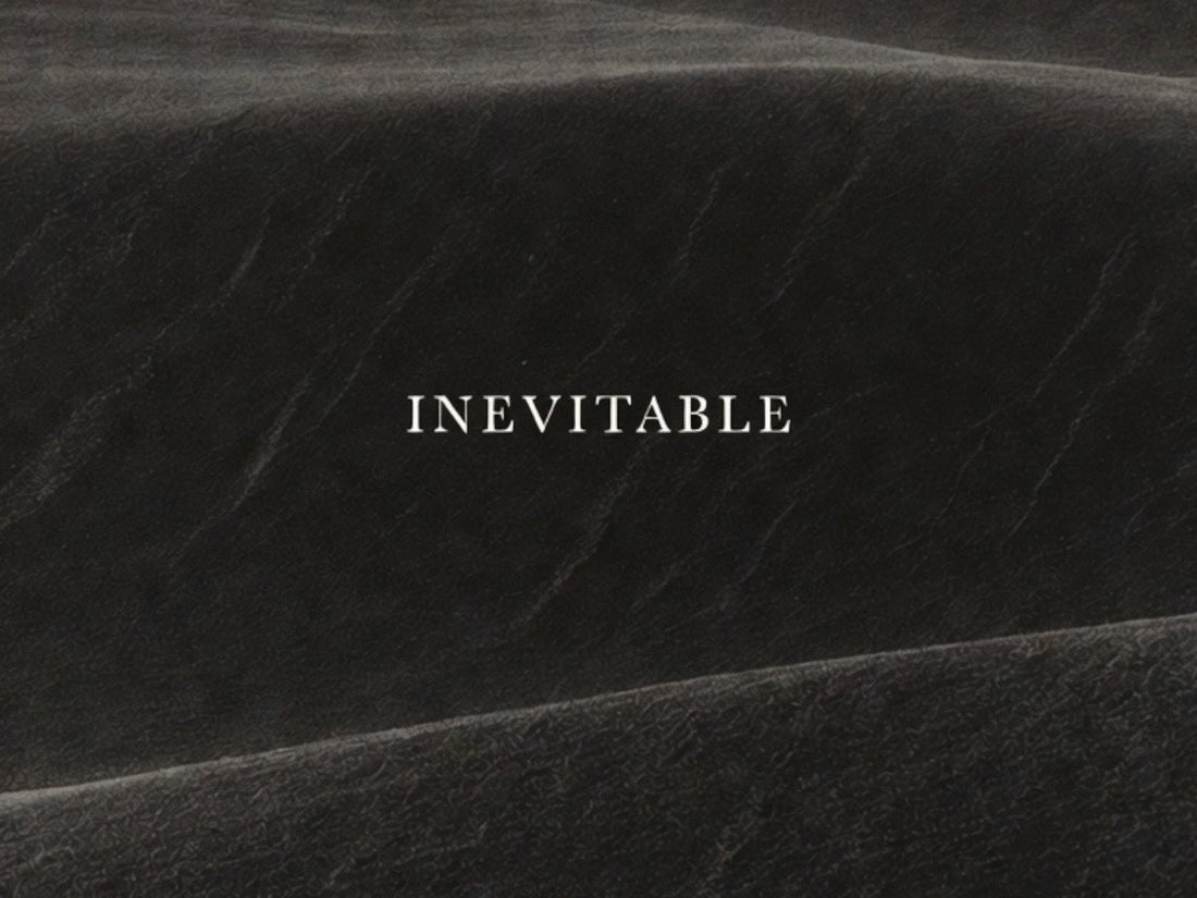 Minimalist black editorial image with subtle texture and the word “Inevitable,” representing R10’s philosophy of quiet luxury, discipline, and enduring presence.