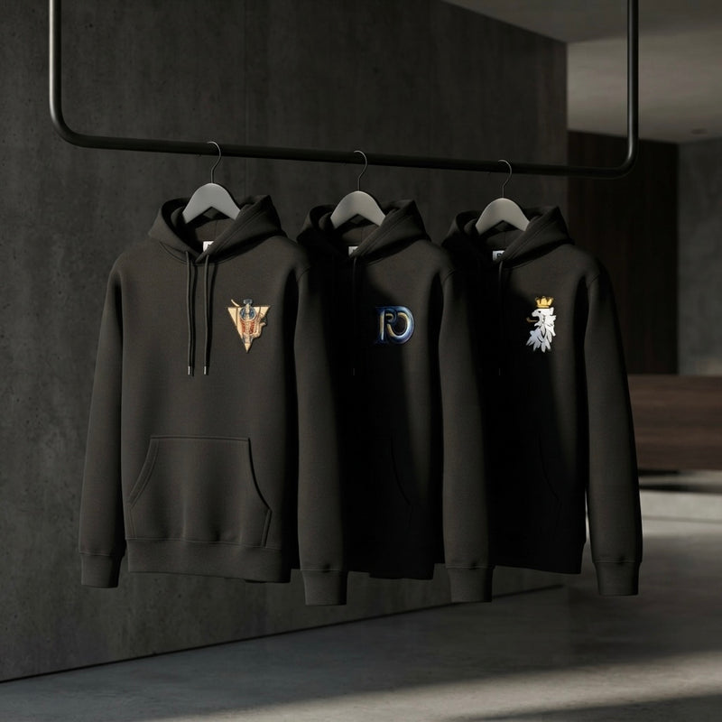Three premium garments displayed on a minimalist clothing rail representing a permanent wardrobe.