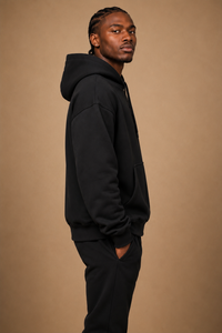 Side profile of the Leão Branco Motif Hoodie showing the relaxed fit, structured hood,and heavyweight drape.