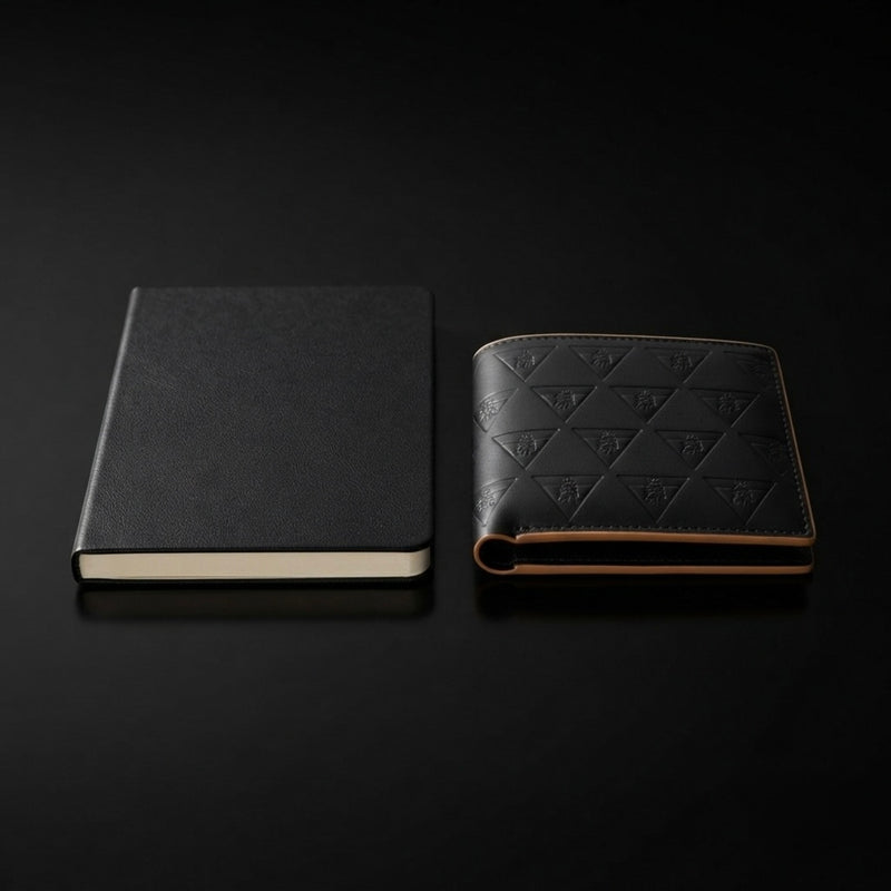 Notebook and leather wallet arranged in a minimalist editorial composition symbolizing structure. 