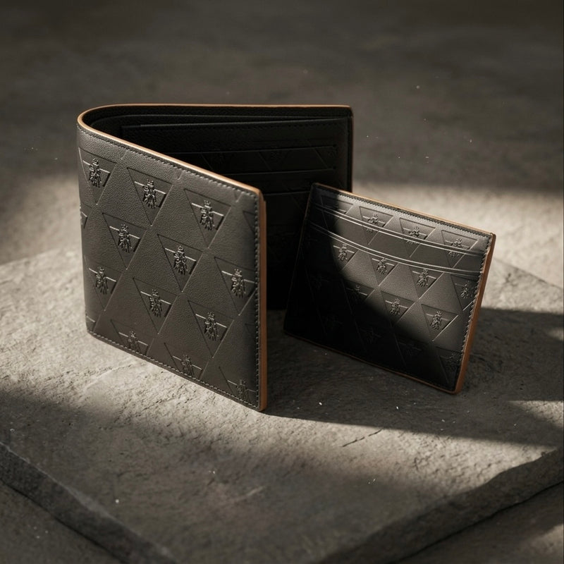 Premium leather cardholder and wallet arranged on a stone surface representing intentional everyday carry.