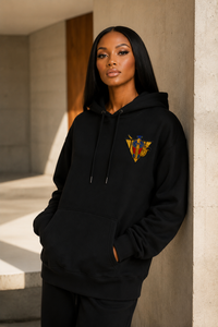 Model wearing the R10 Uraeus e Abutre Emblem Hoodie in a minimalist architectural setting that emphasizes timeless everyday design.