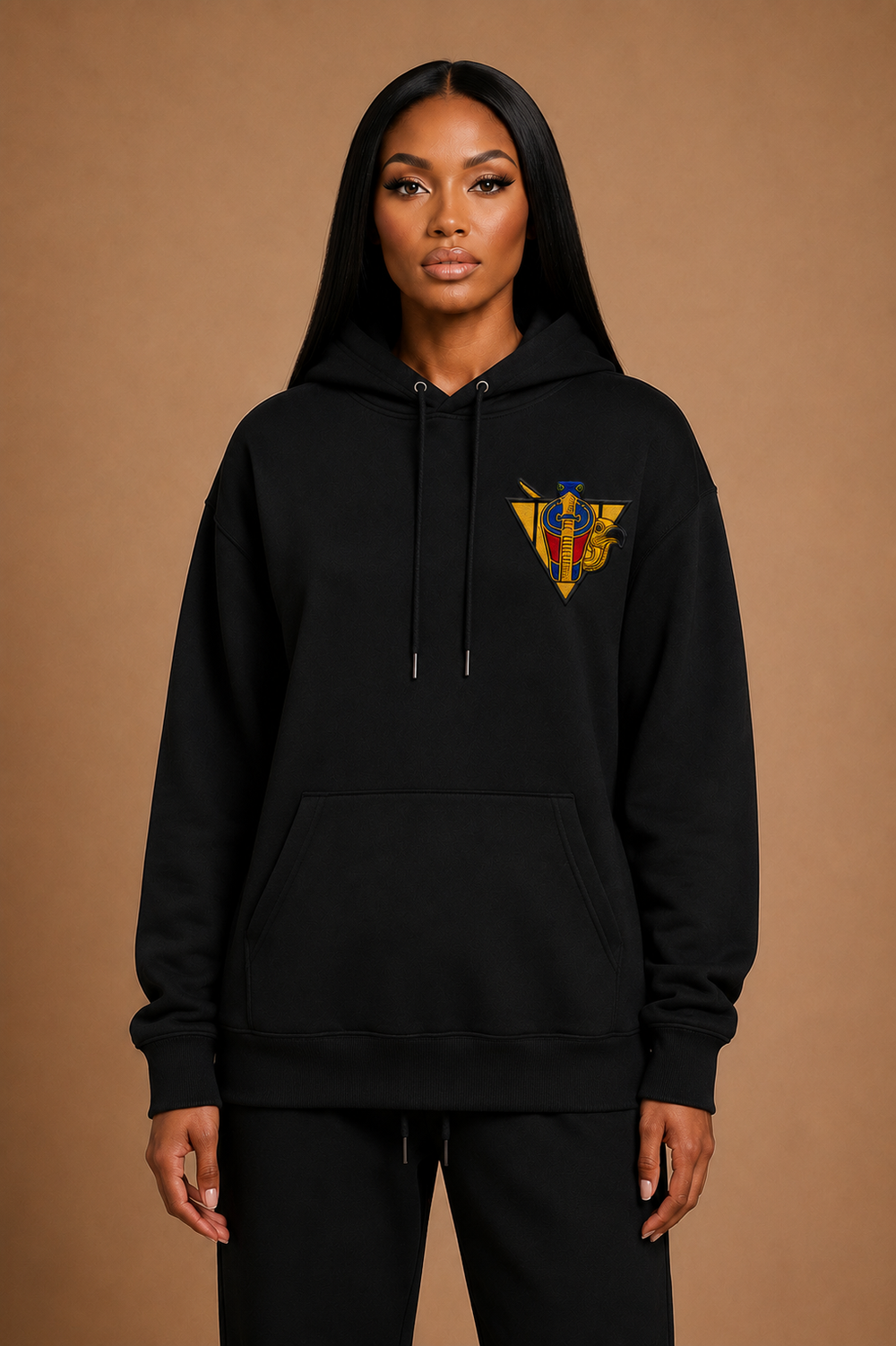 Model wearing the Uraeus e Abutre Emblem Hoodie in black, showcasing the relaxed fit, heavyweight construction, and embroidered Uraeus e Abutre Emblem.