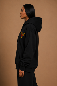 Side profile of the R10 Uraeus e Abutre Emblem Hoodie showing the relaxed fit, structured hood, and heavyweight drape.