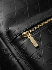 Close-up detail of full grain leather backpack texture, stitching, and craftsmanship