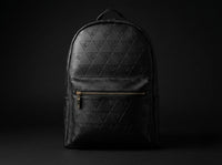 Front view of Leão Branco Motif leather backpack showing structured design and minimalist daily carry style