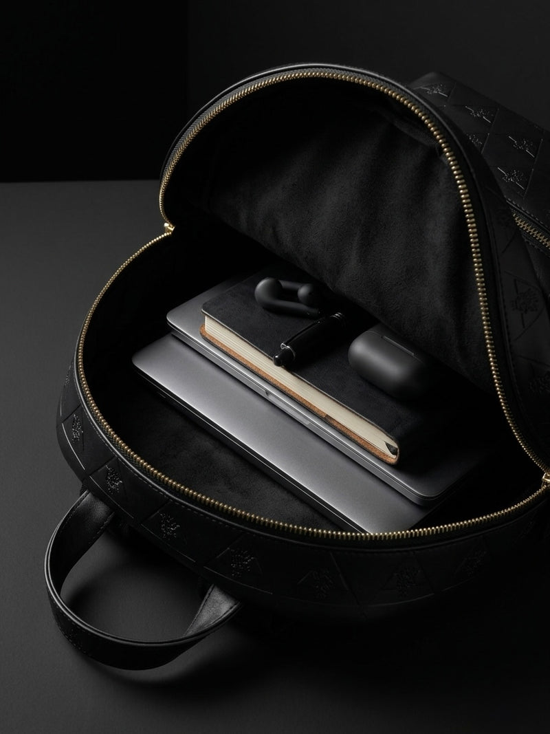 Open leather backpack showing organized space for daily essentials and controlled carry