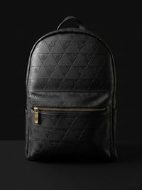 Leão Branco Motif full grain leather backpack on a dark background with structured silhouette for daily carry