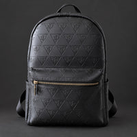 Front view of the black R10 Leão Branco backpack showing embossed motifs, top handle, and zippered front pocket.