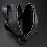 Open R10 backpack showing the black-lined main compartment and zipper opening.