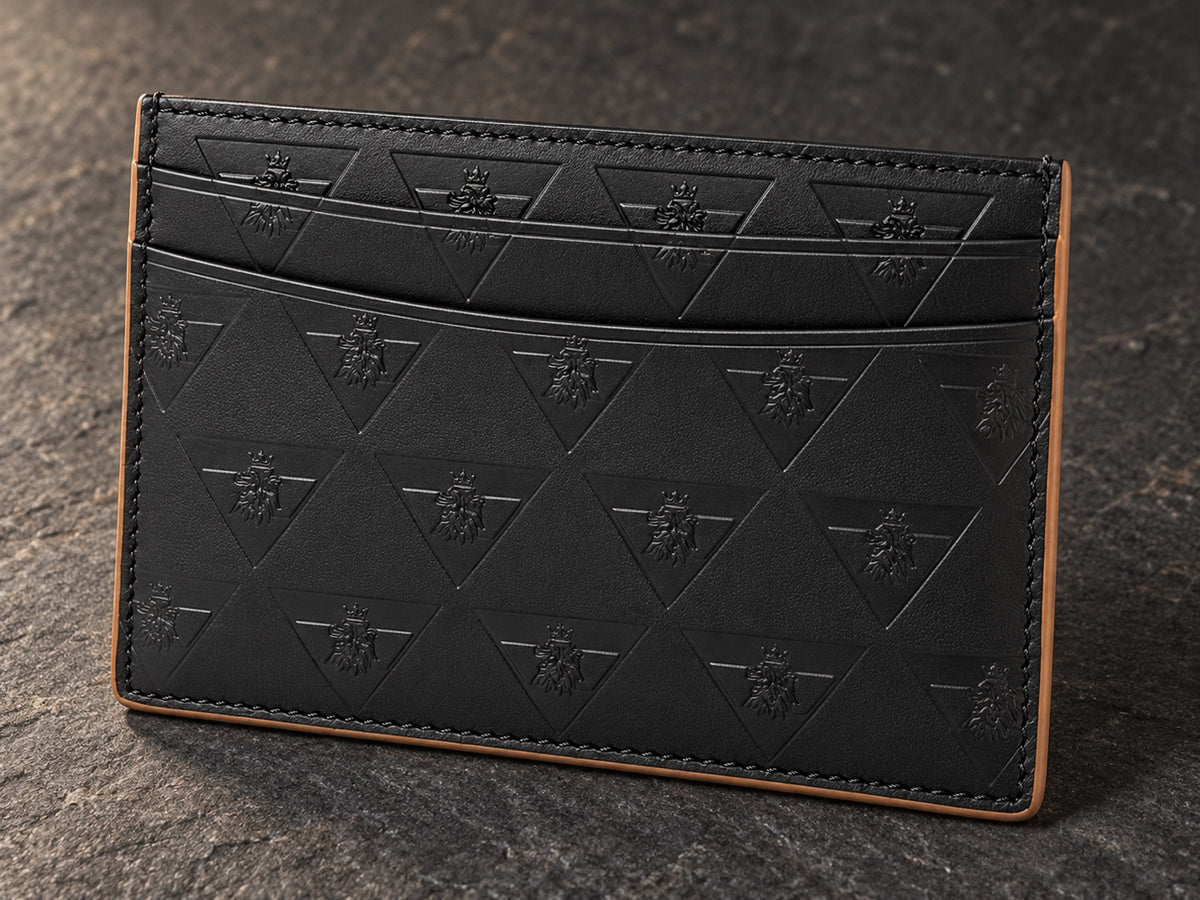 The R10 cardholder on dark stone, showing layered card slots, perimeter stitching, and finished edges.