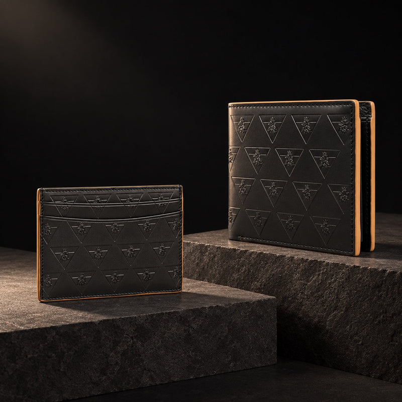 Black R10 cardholder and wallet displayed on separate charcoal stone planes.