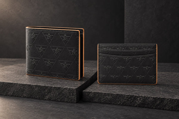 Black R10 wallet and cardholder displayed separately on charcoal stone.