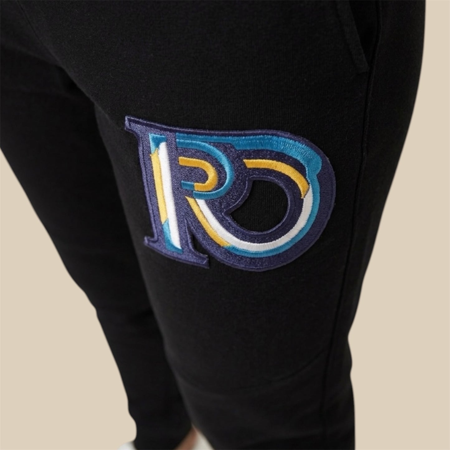 R10 black joggers Monogram embroidery detail
