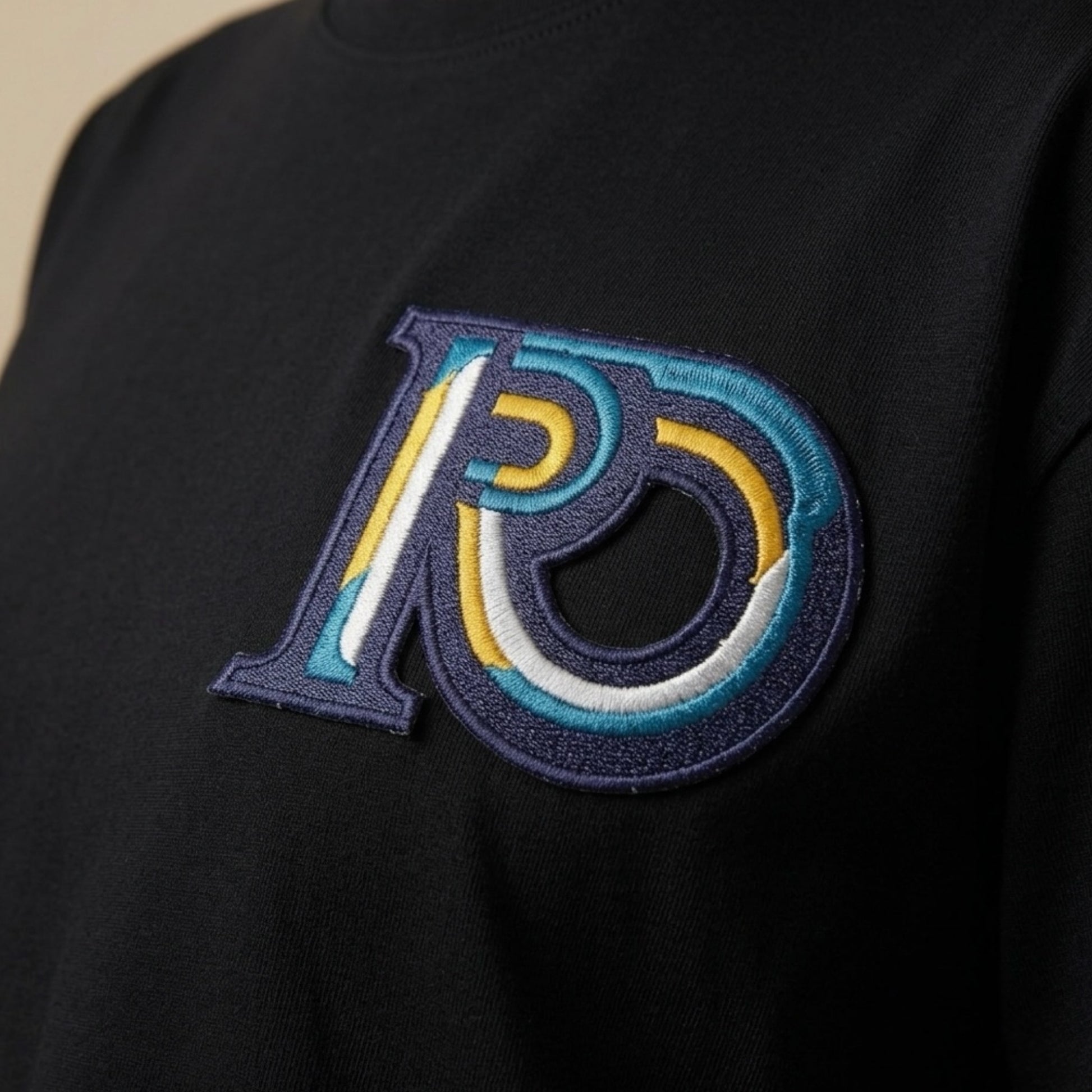 R10 black tee Monogram embroidery detail