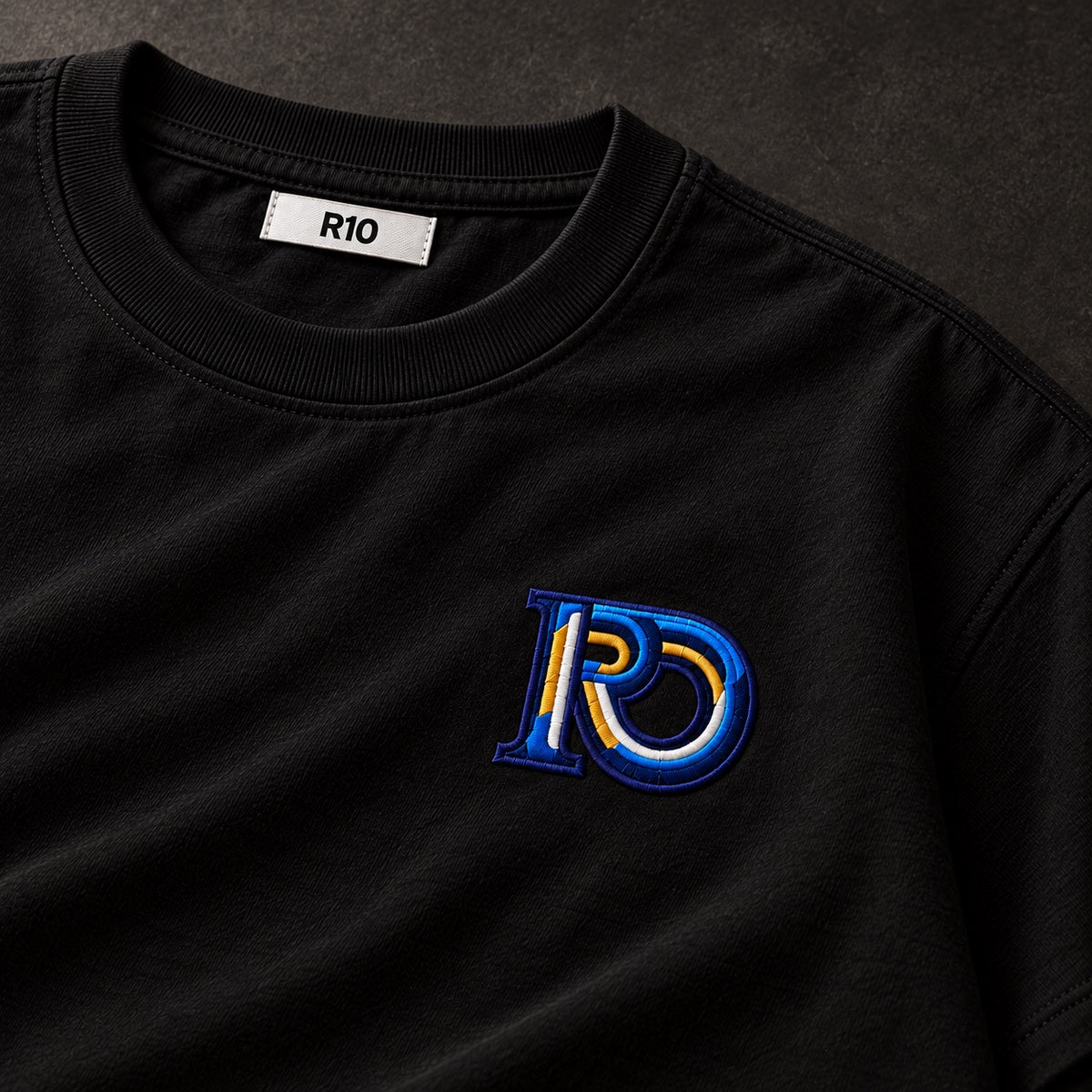 Black R10 Monogram Tee — embroidery detail and inside R10 collar label.