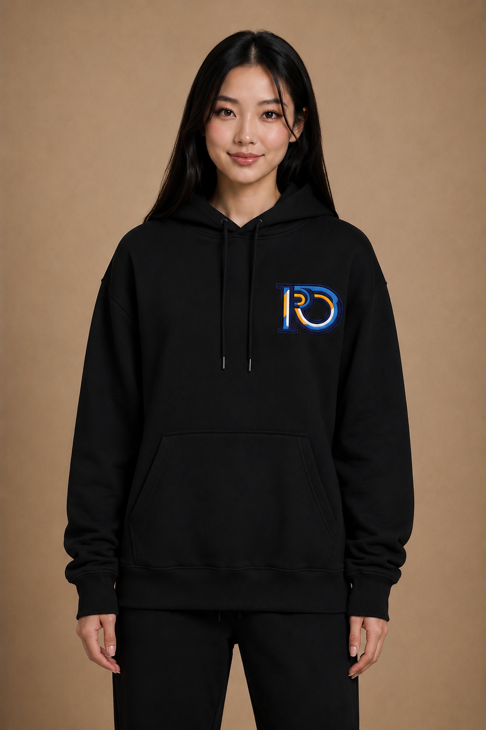 Model wearing R10 Monogram Hoodie in black, showcasing the relaxed fit, heavyweight construction, and embroidered R10 Monogram.