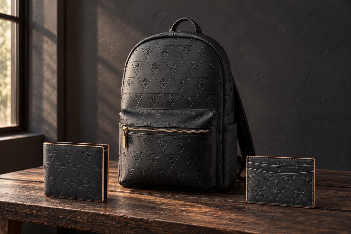 R10 backpack, closed wallet, and cardholder arranged separately on a timber bench beside a shaded window.