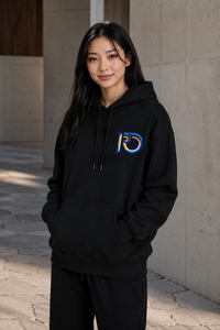 Model wearing the R10 Monogram Hoodie in a minimalist architectural setting that emphasizes timeless everyday design.
